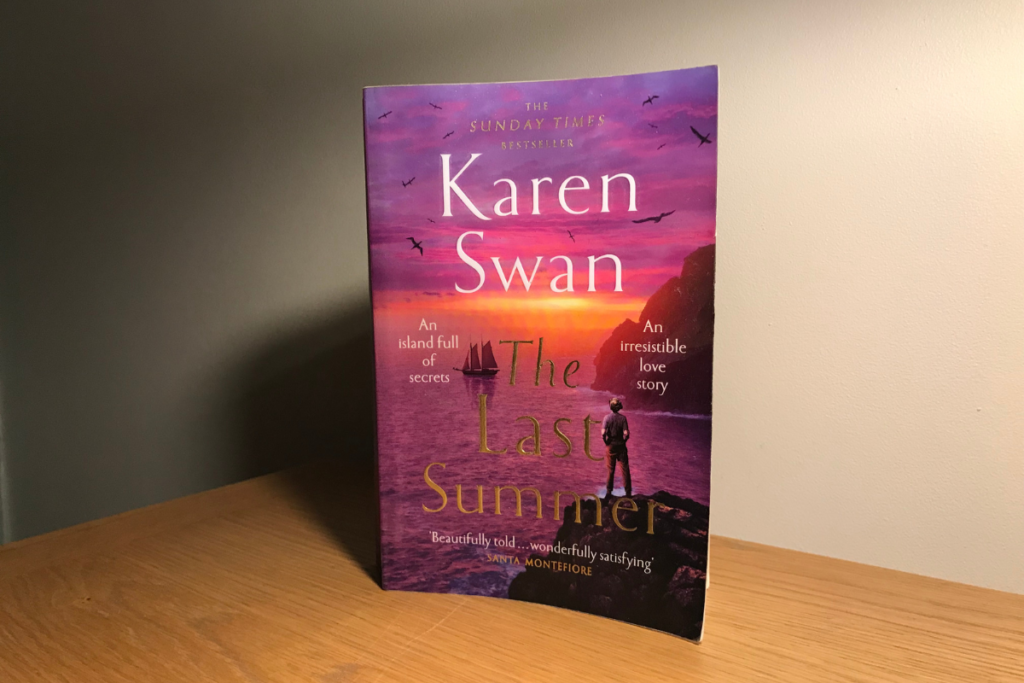 The Last Summer by Karen Swan sitting on an wooden shelf