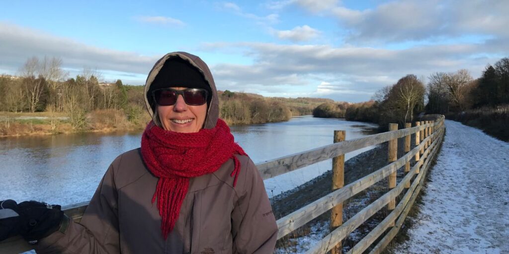 Jackie Watson standing on the banks of the River Tyne on a wintery January day