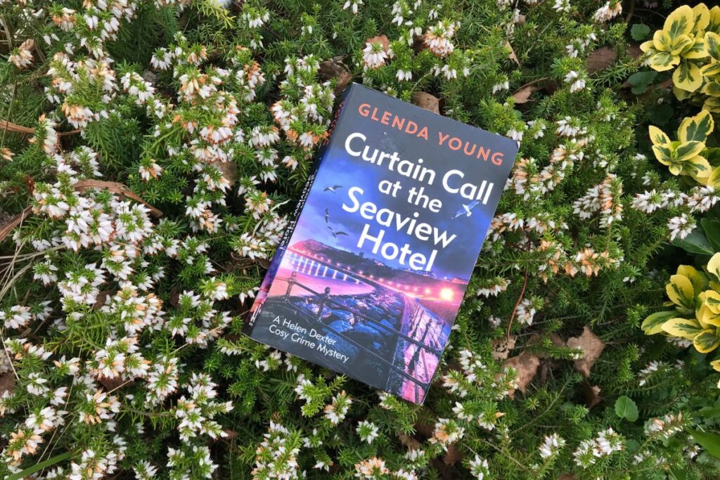 Curtain Call at the Seaview Hotel by Glenda Young resting on a bed of white heather